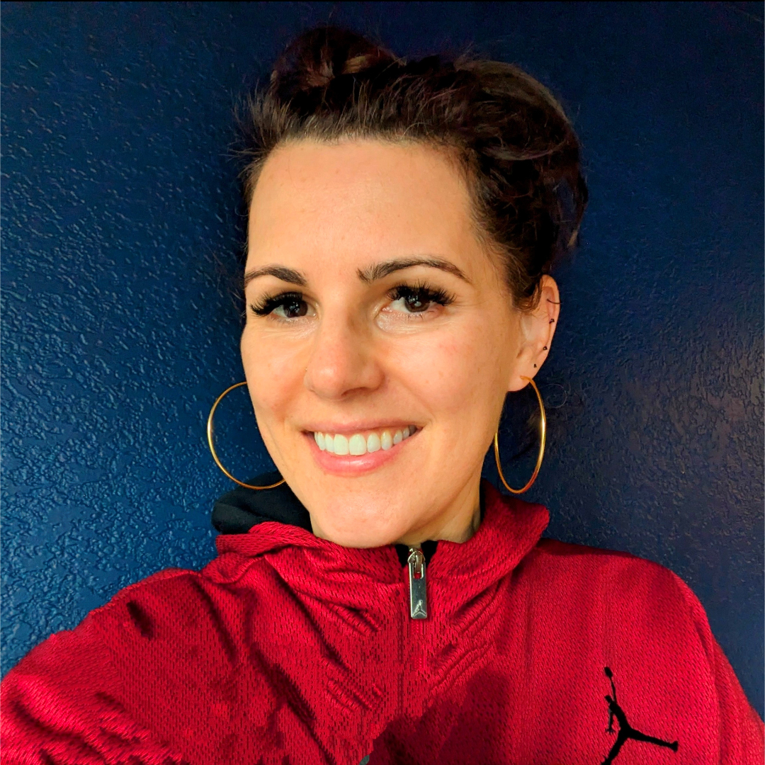 Rebecca Garrow: white woman with dark brown hair wearing a red jacket.