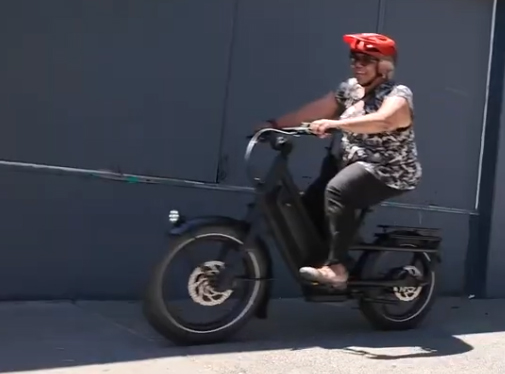 A woman rides an e-bike.
