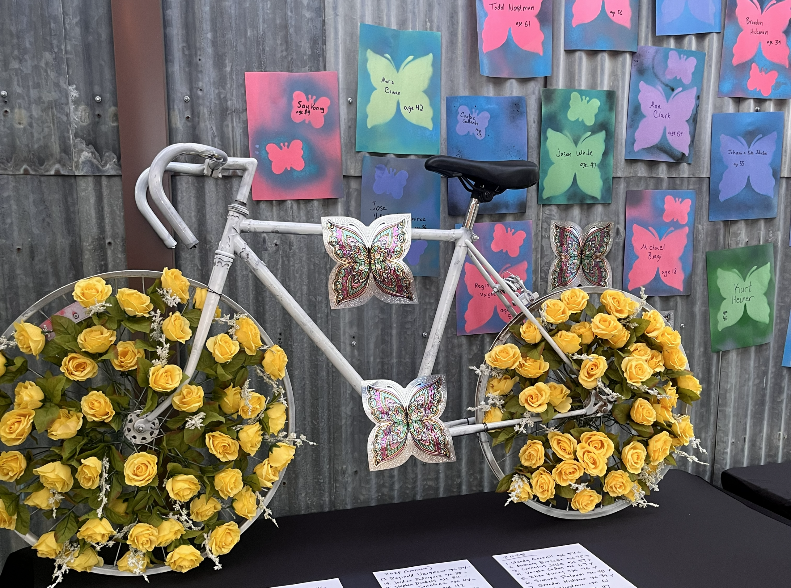 A bike with yellow roses woven into the spokes of the tires.